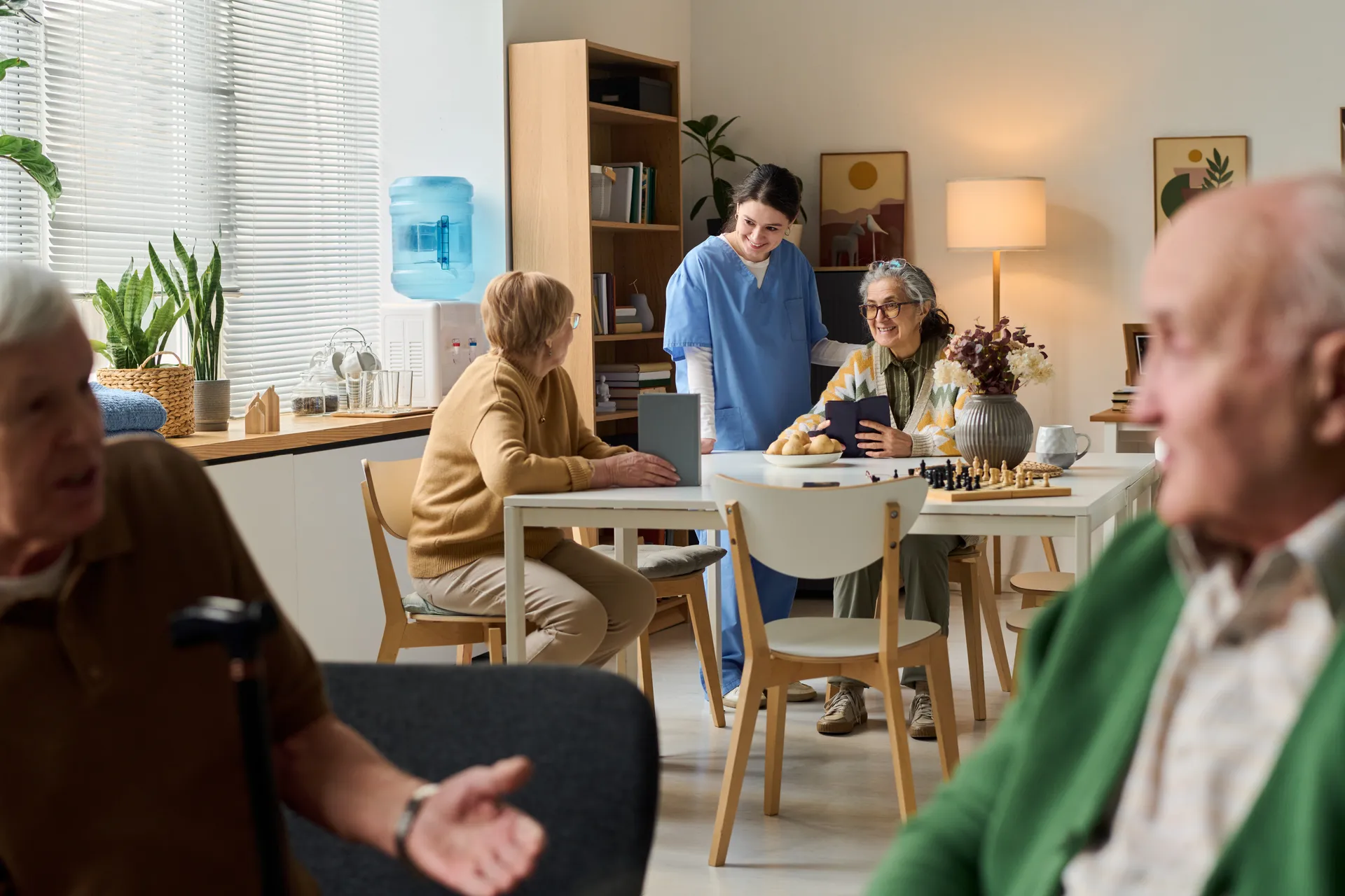 Residents and a caregiver in a community common room