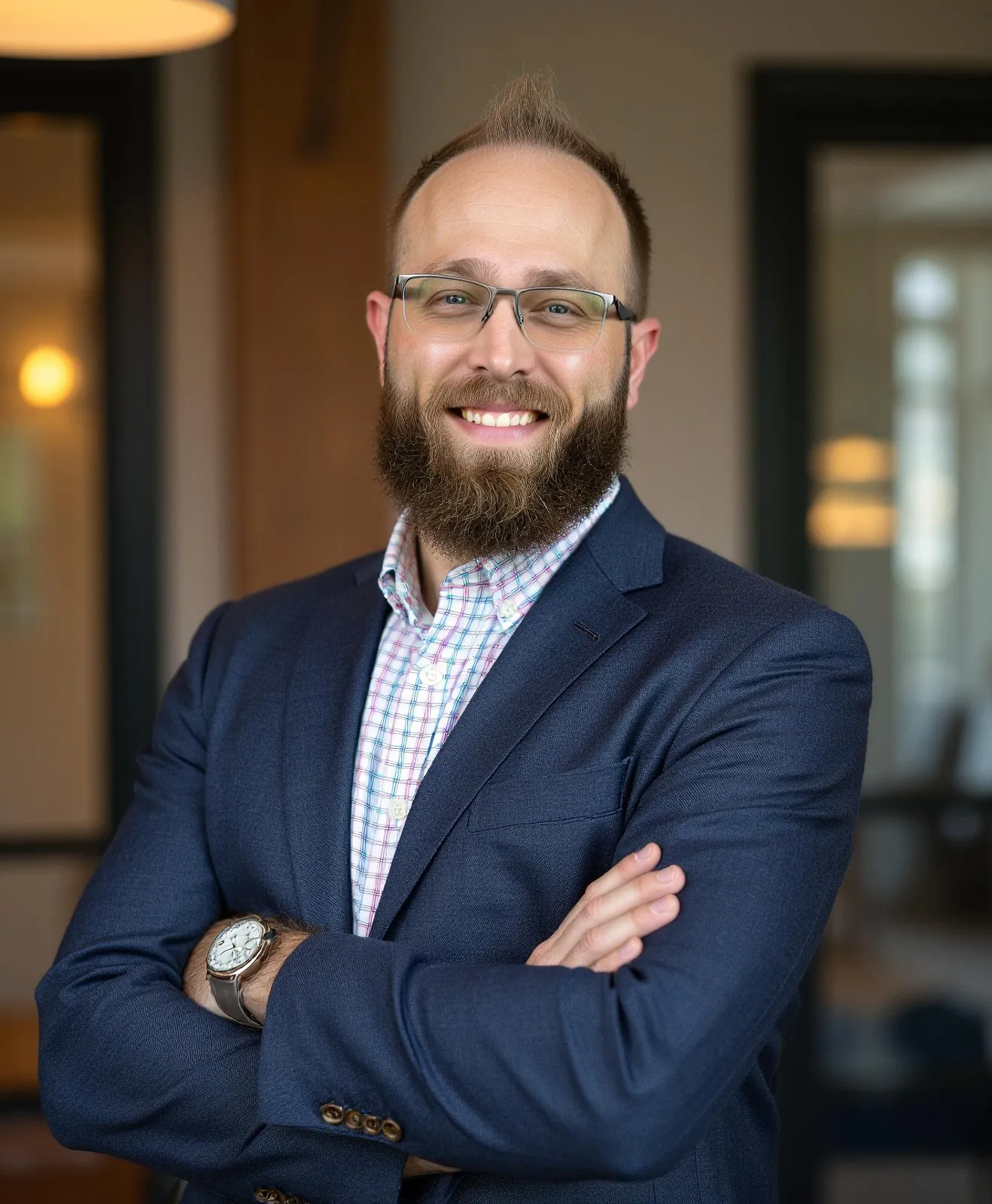 J. Adam Palmer, founder of Inertia Digital Marketing, arms crossed in a navy blazer