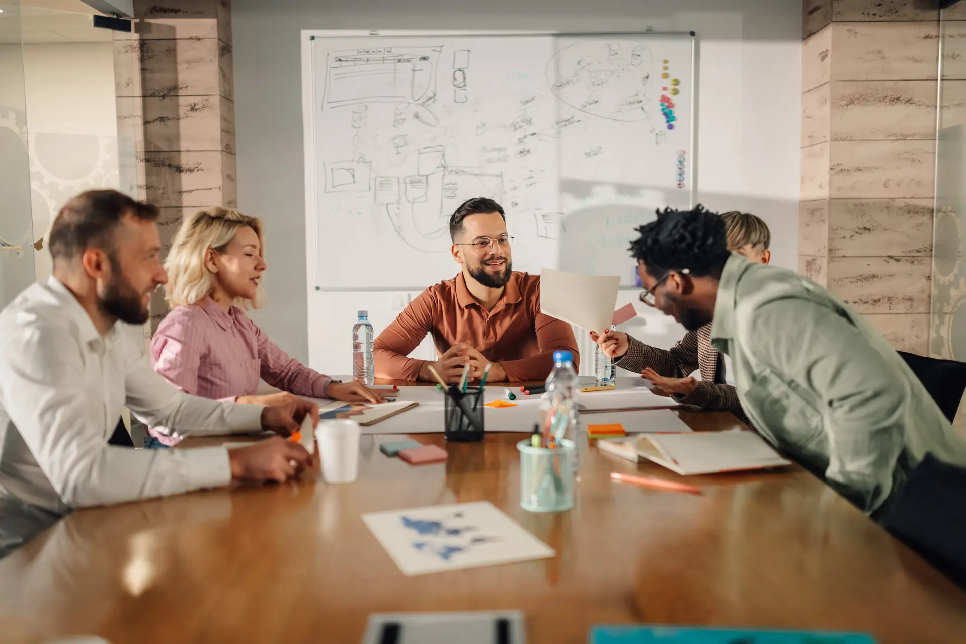 A team working through a plan around a conference table
