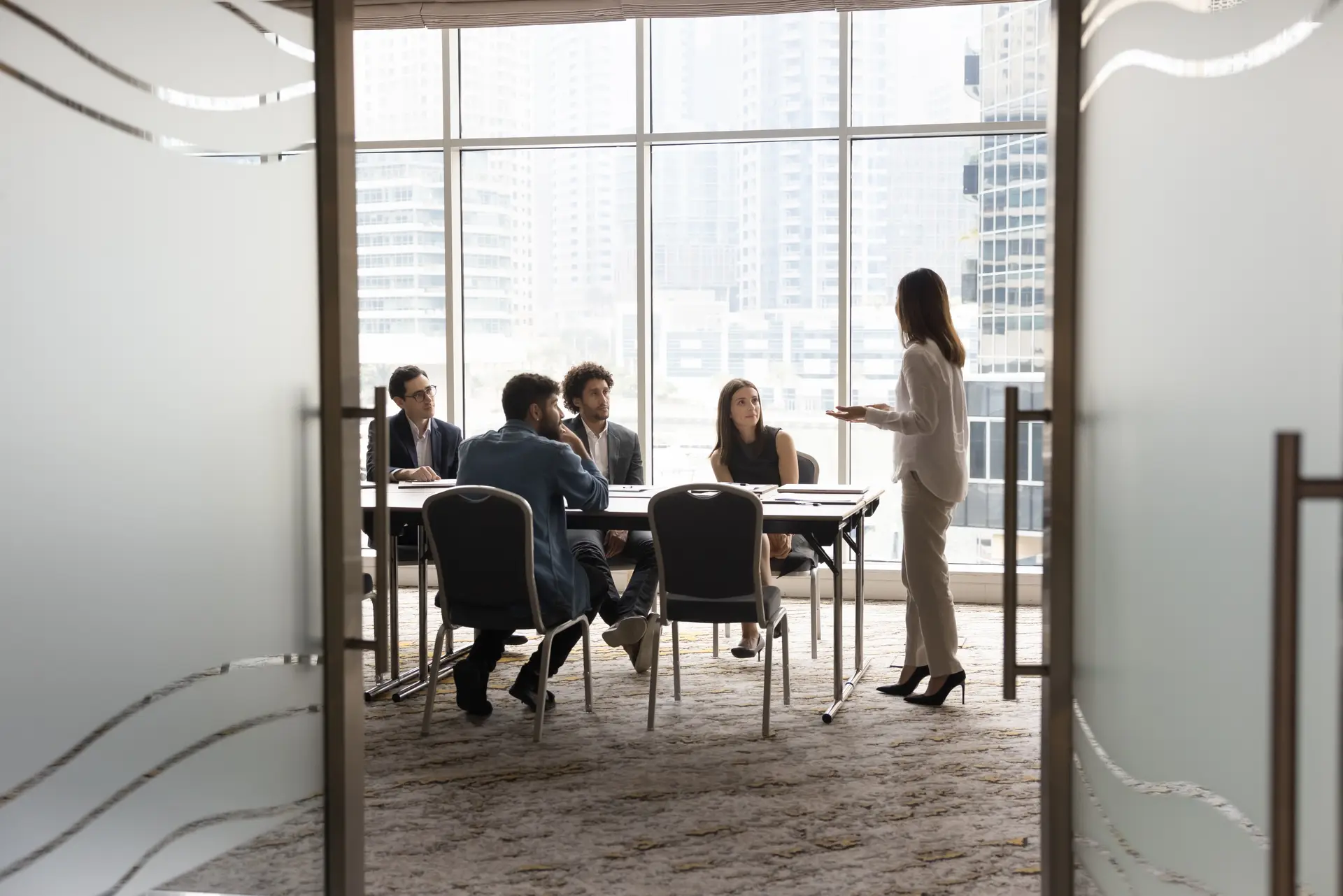 Looking through a doorway into a glass-walled meeting room